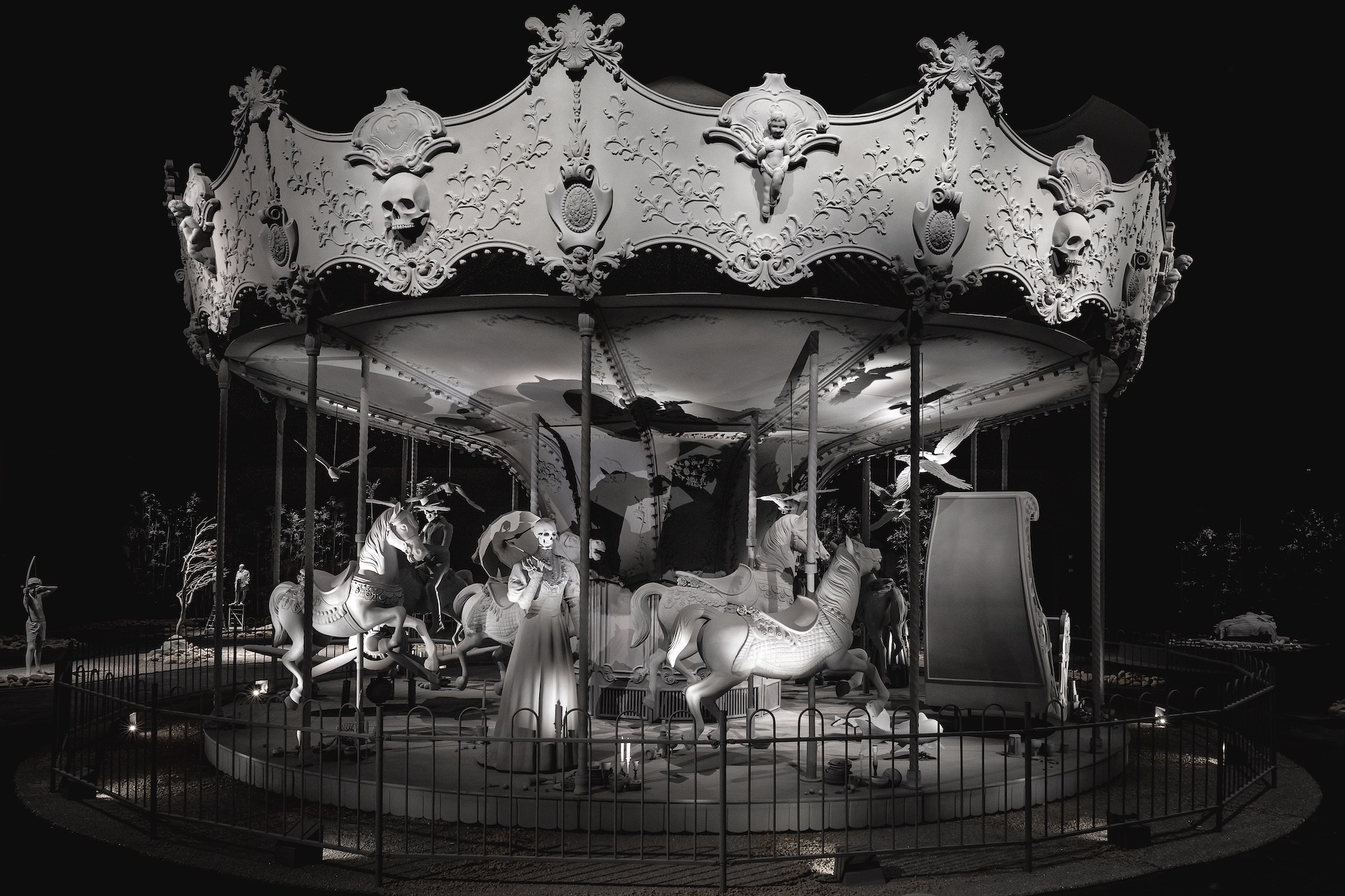 An installation of a carousel, completely covered in grey.