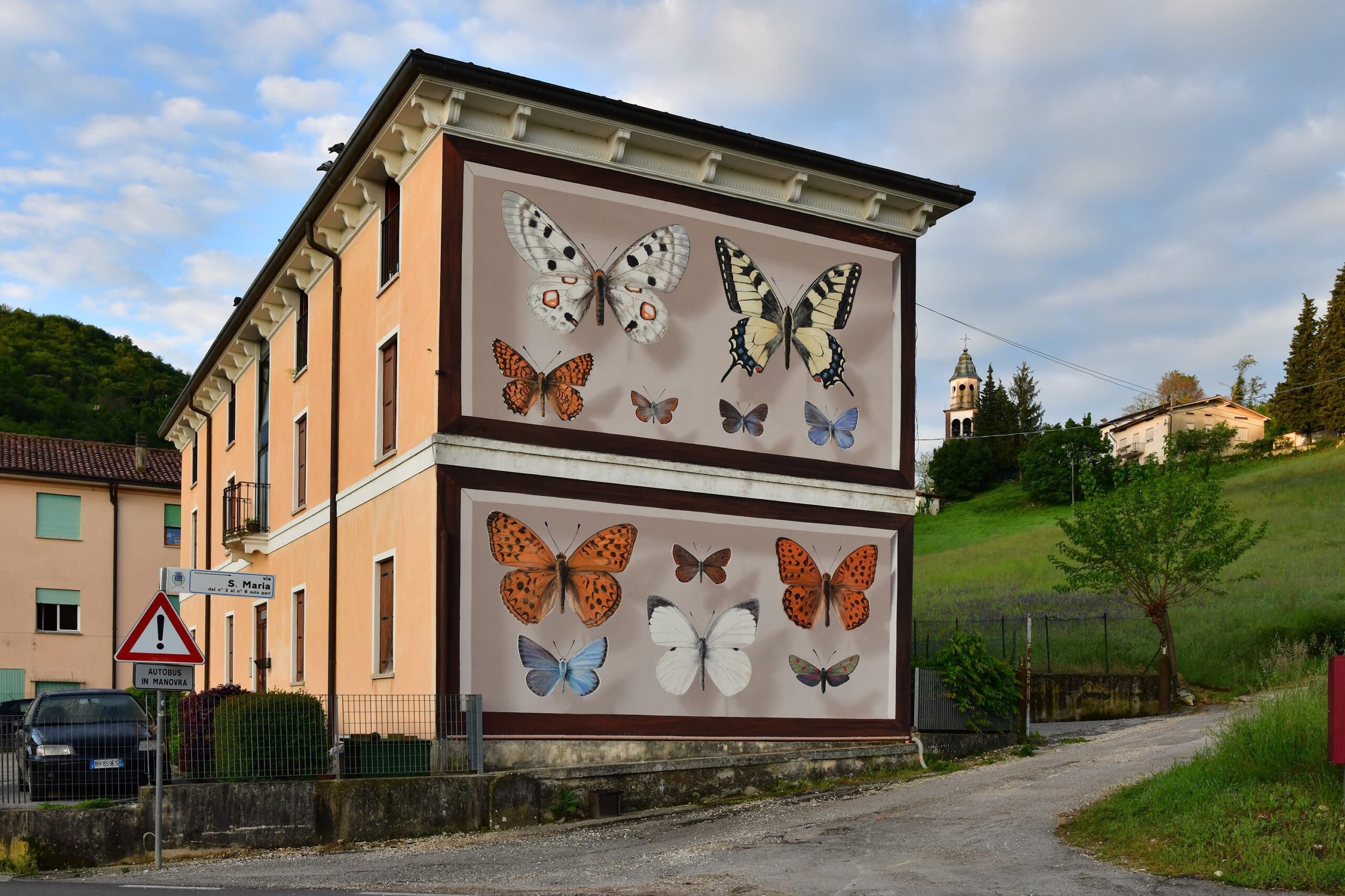 Large butterfly mural on the side of a building