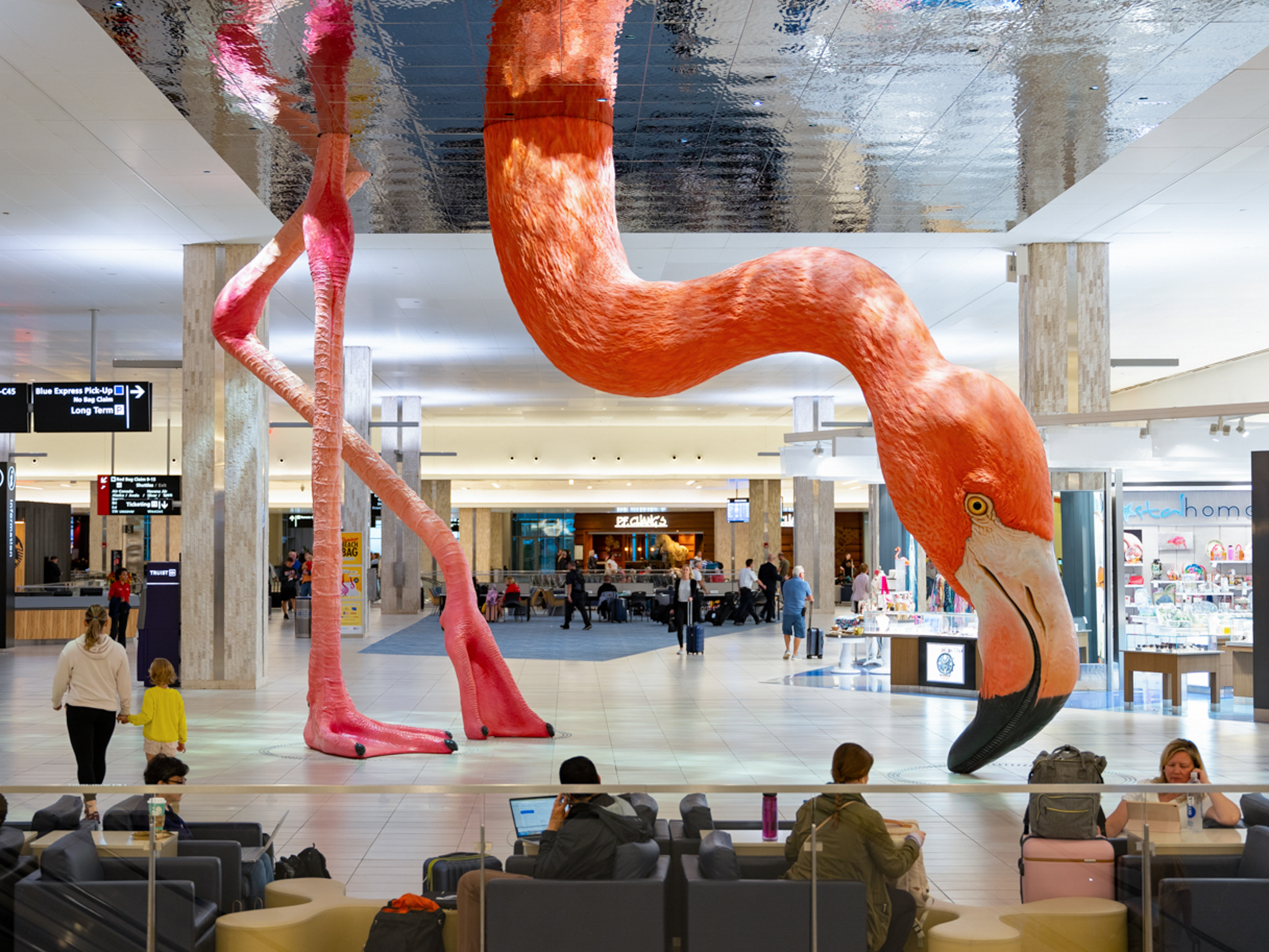 A monumental installation in an airport terminal of a realistic flamingo.