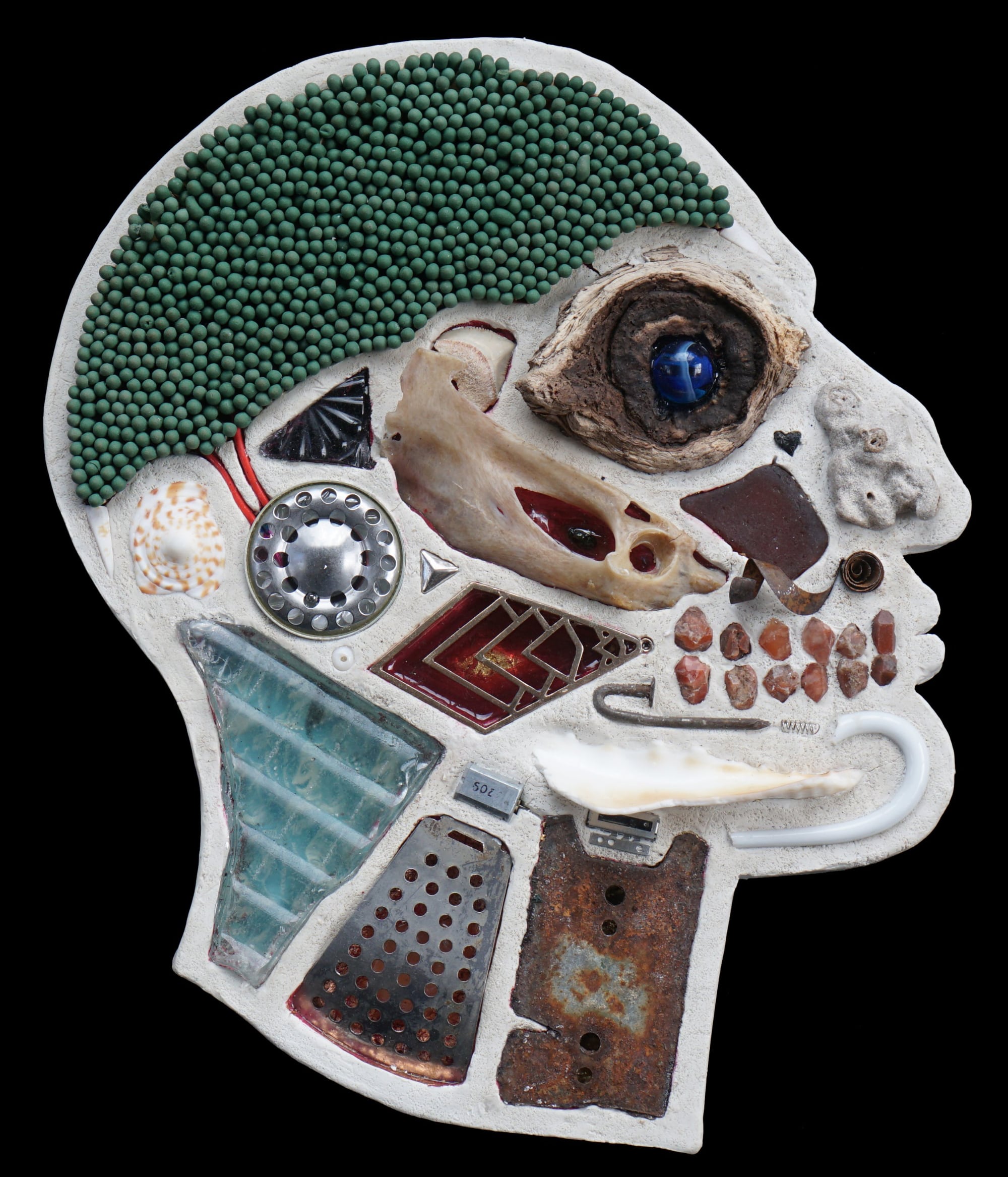 An anatomical sculpture of a head filled with found objects