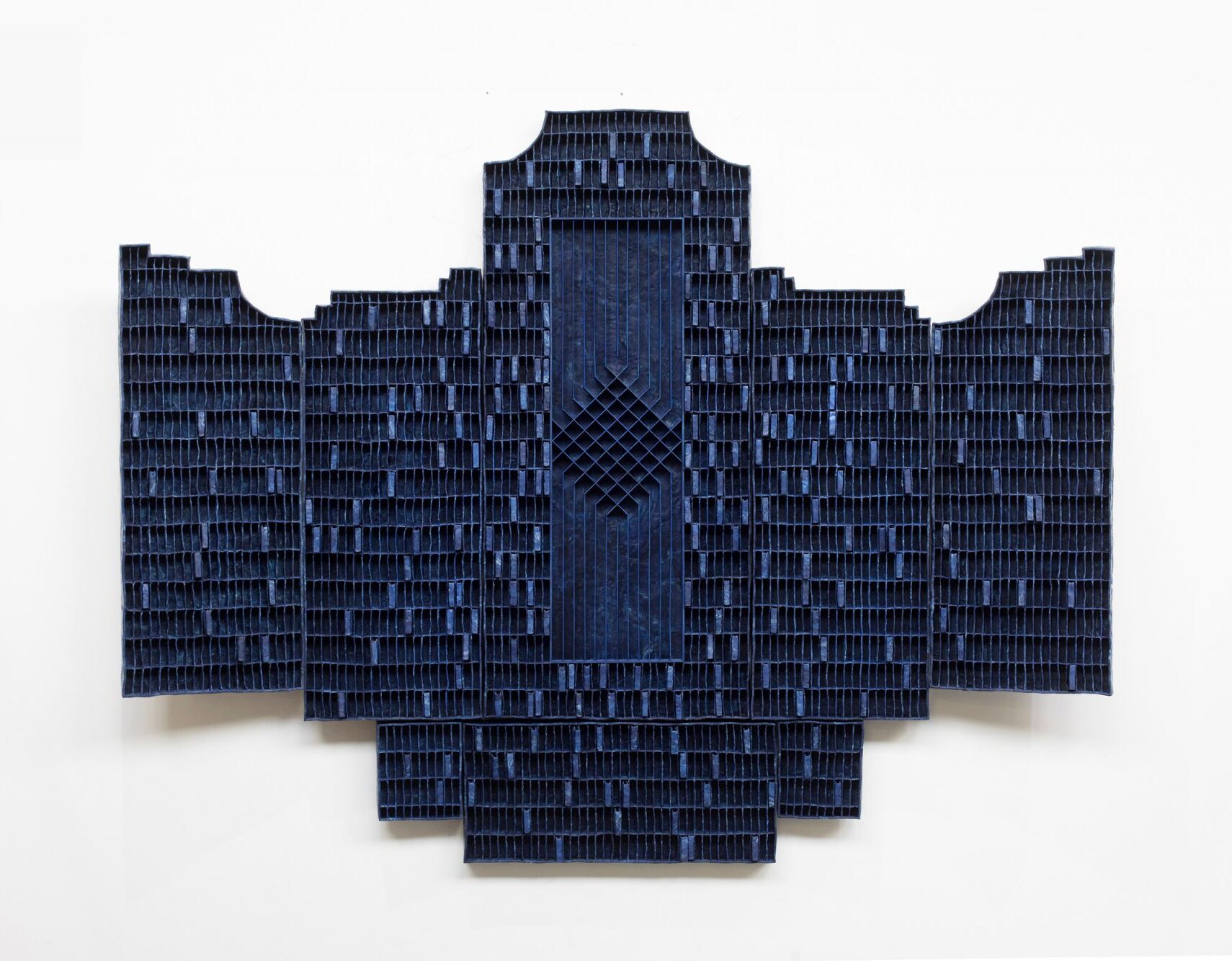 A blue, geometric artwork that resembles the outline of an altarpiece.
