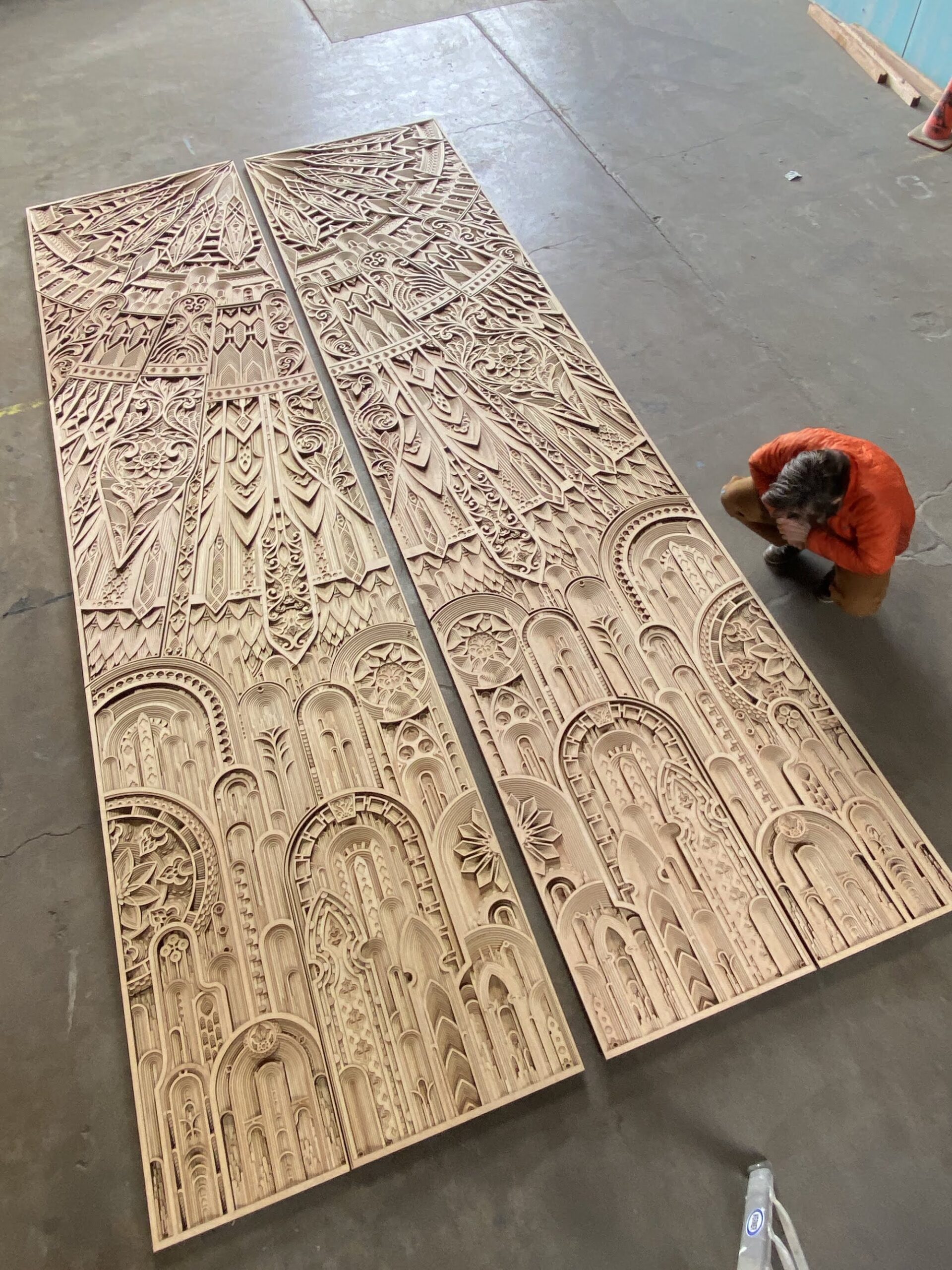 Two panel reliefs made from layers of laser-cut plywood.