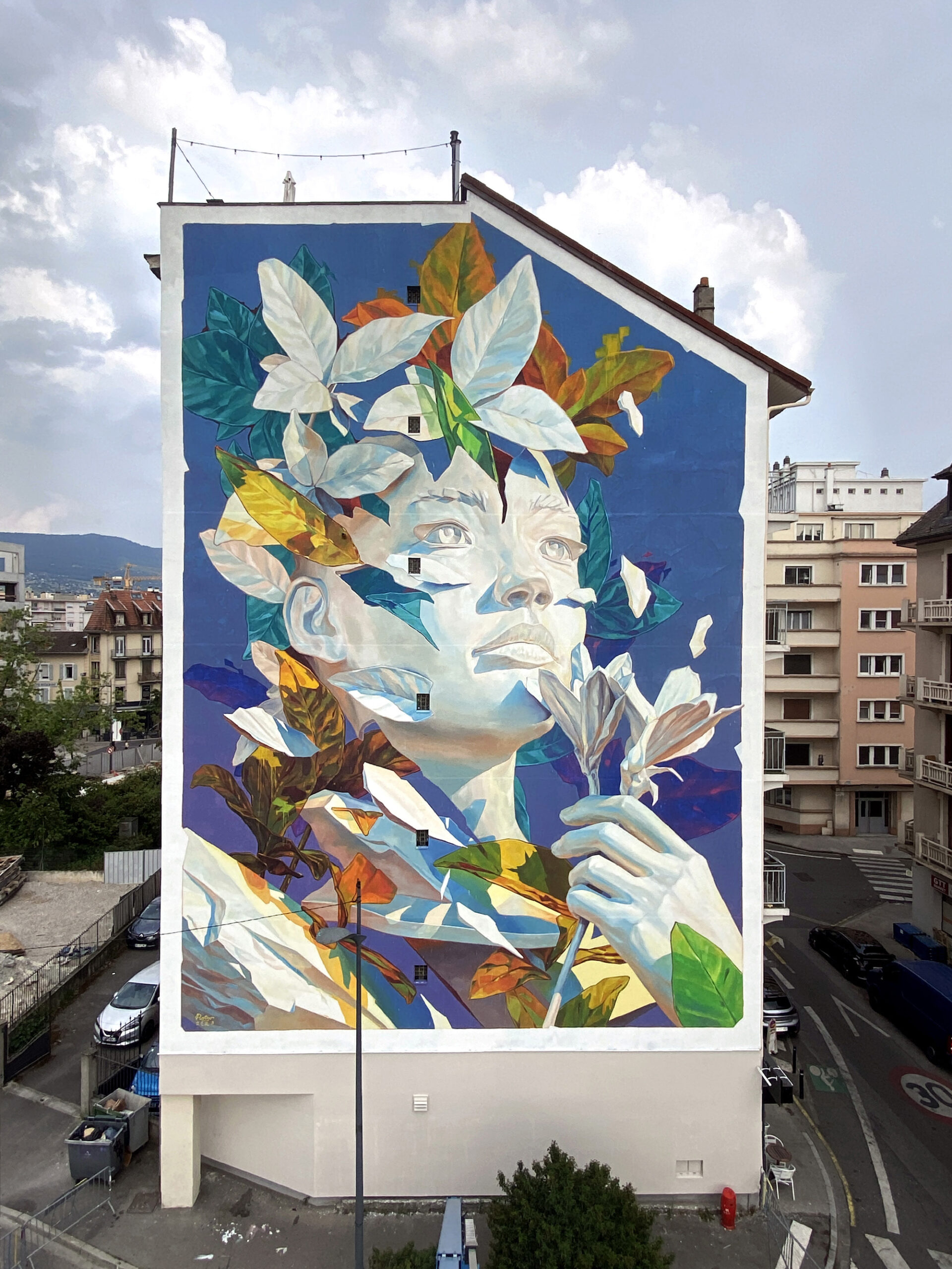 A mural of a young woman with leaves bursting from her head and shoulders.