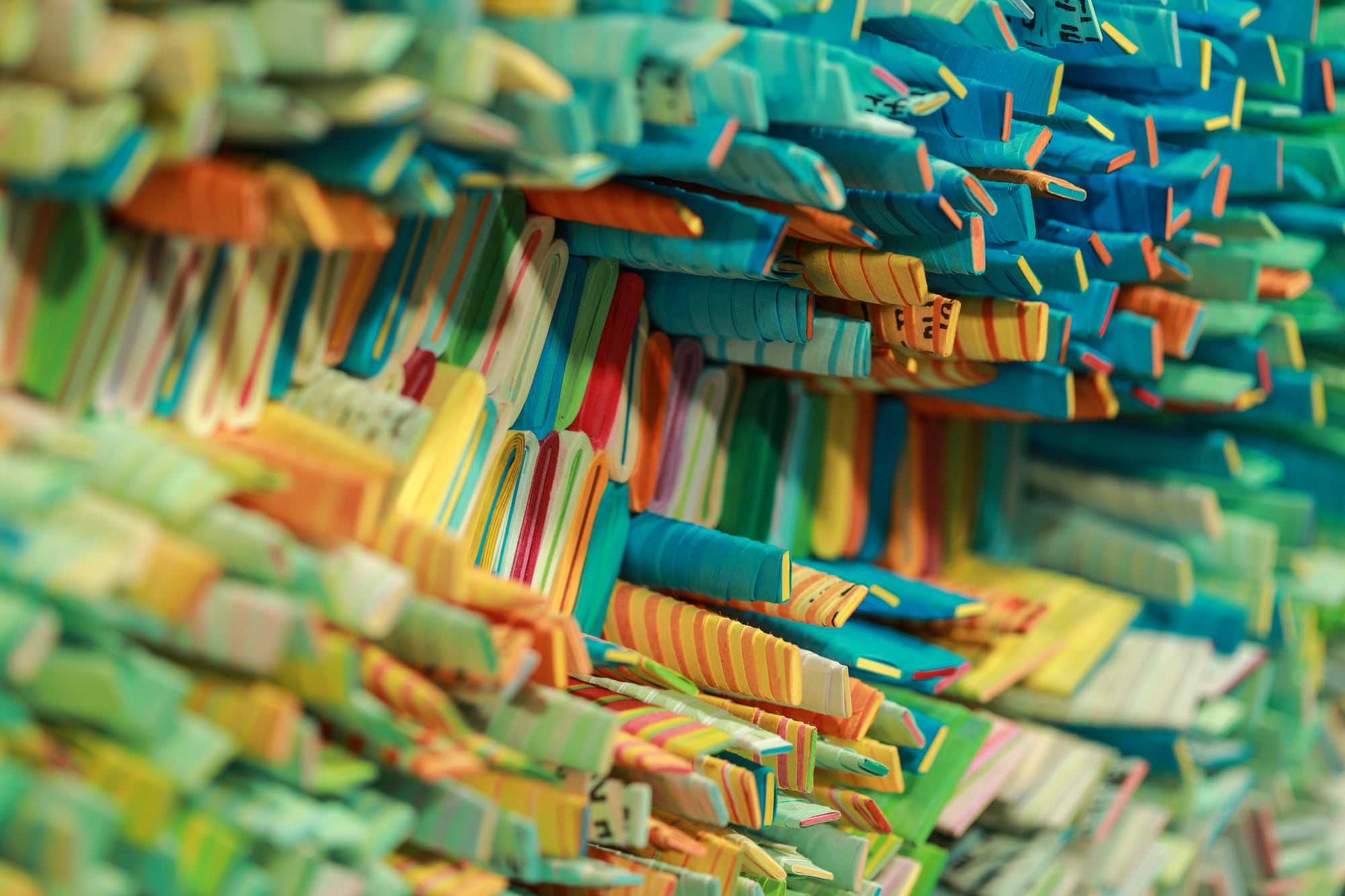 a close up image of colorful rolled paper tightly packed together