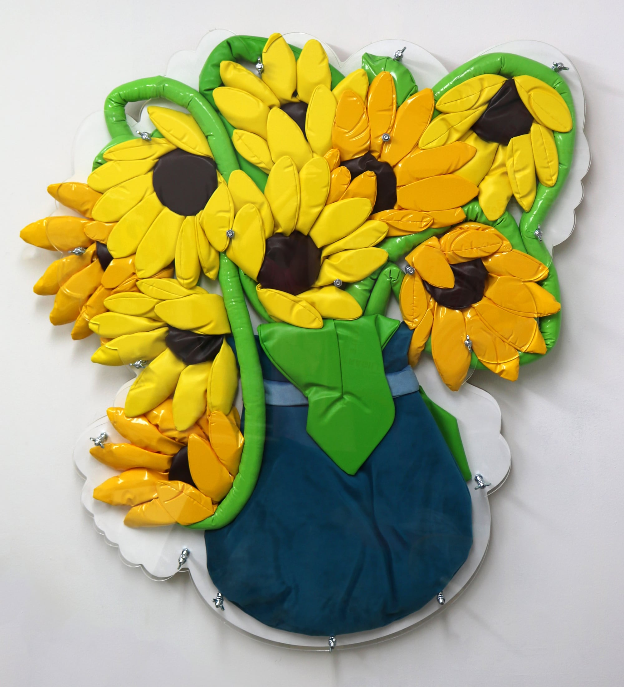 sunflowers are squashed under a clear acrylic panel