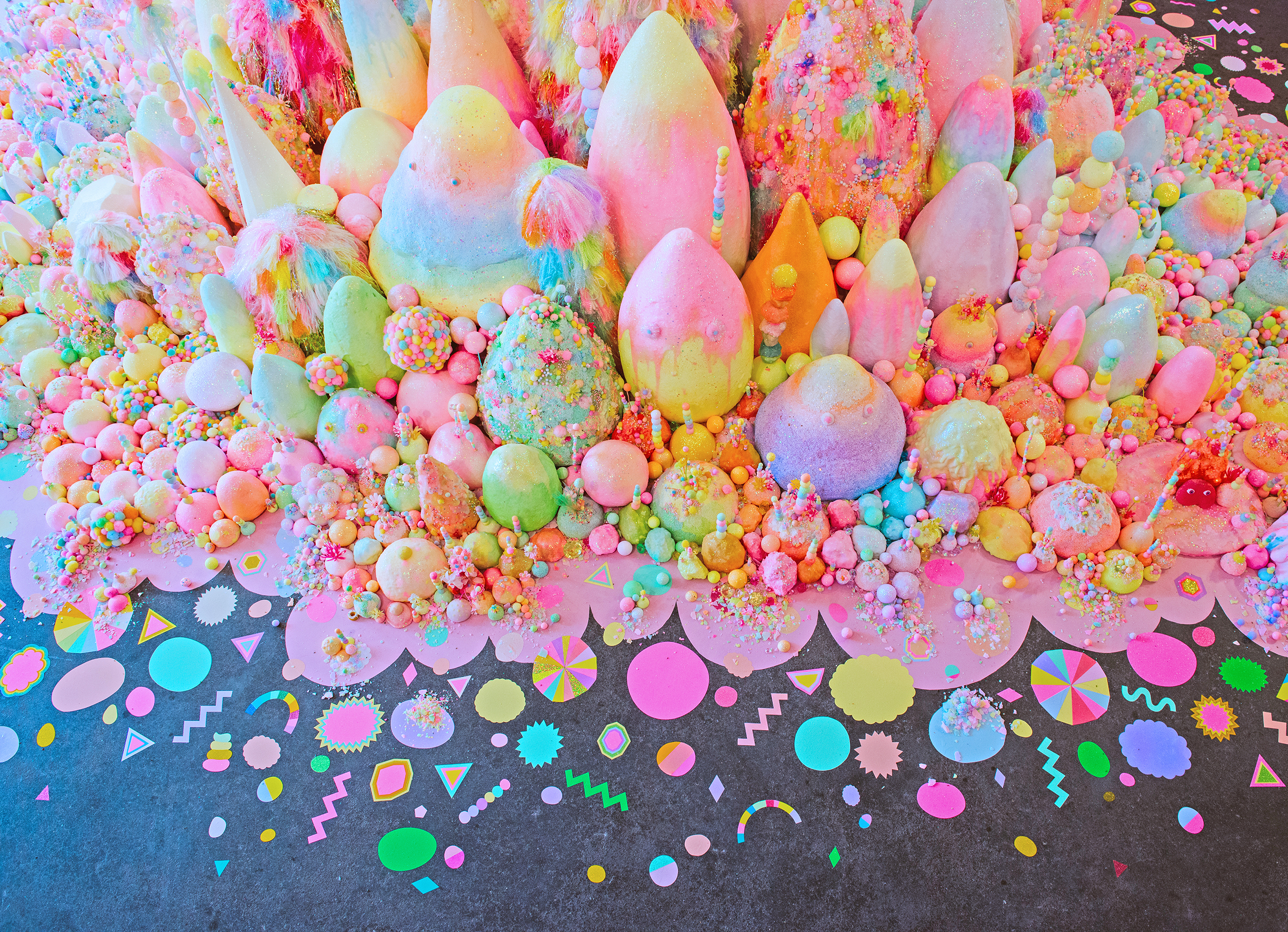 A colorful installation of candy-like sugar and mixed-media sculptures.