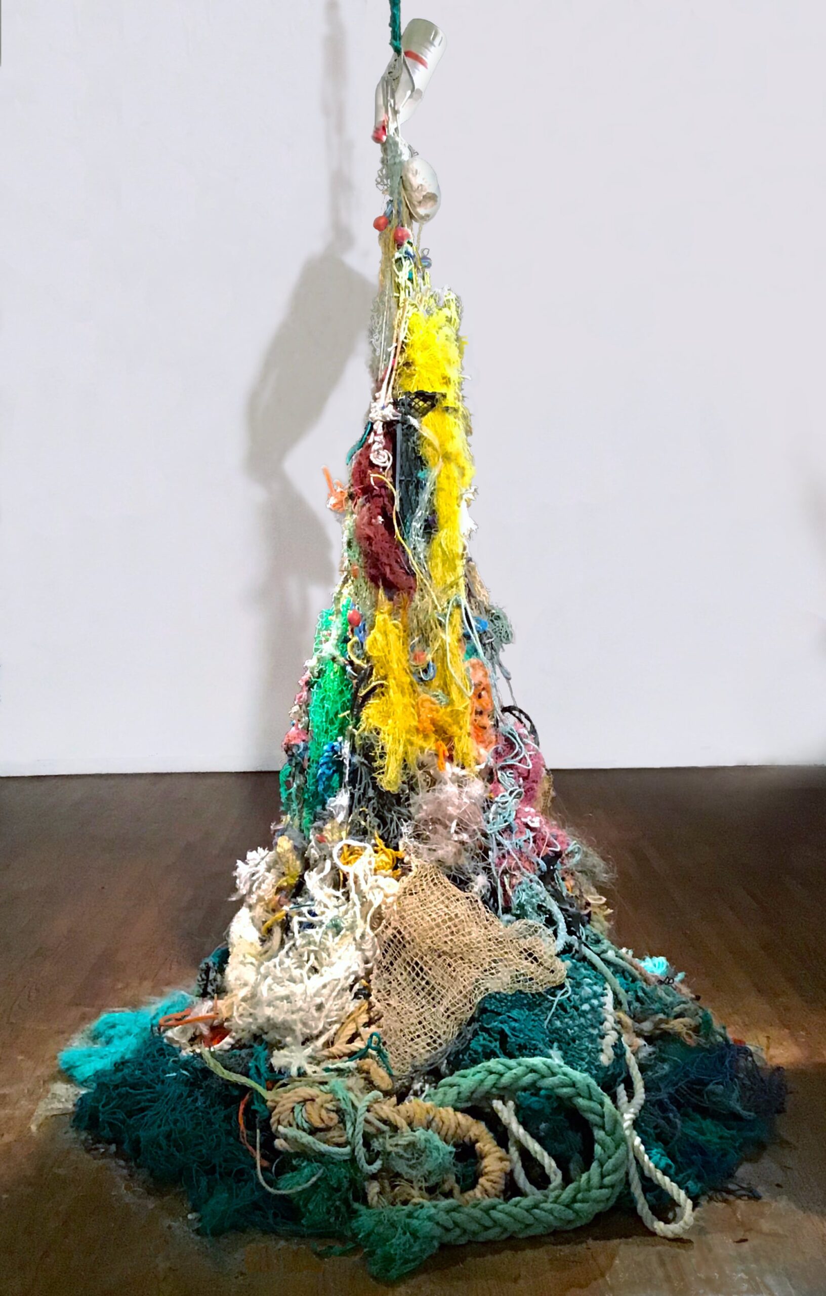 a tangled, suspended sculpture of colorful nets and ropes