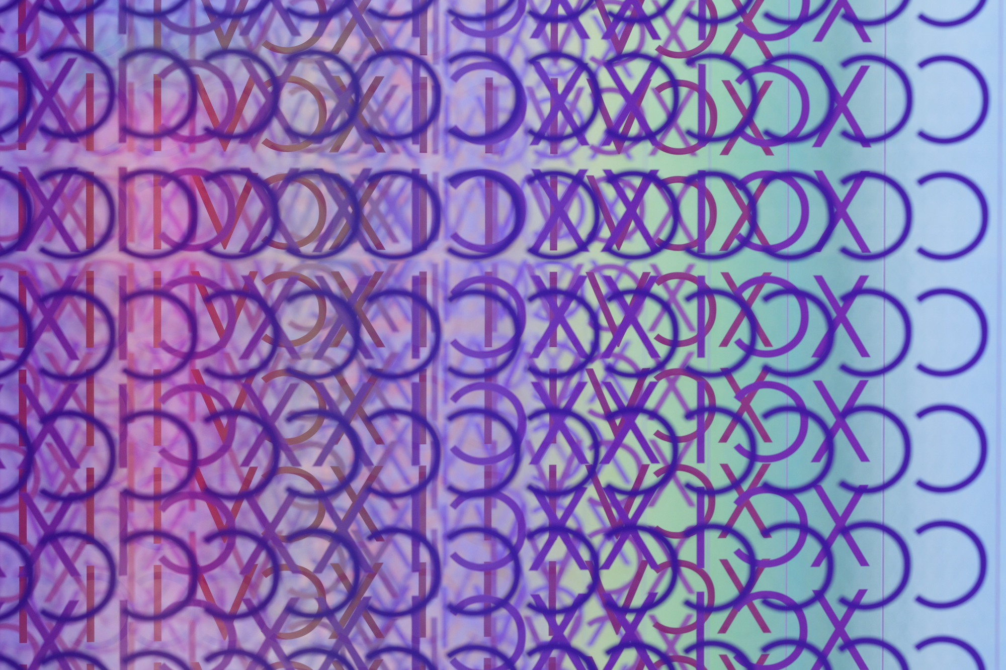A detail of a large-scale installation of thousands of colorful Roman numerals, showing mostly purple letters.