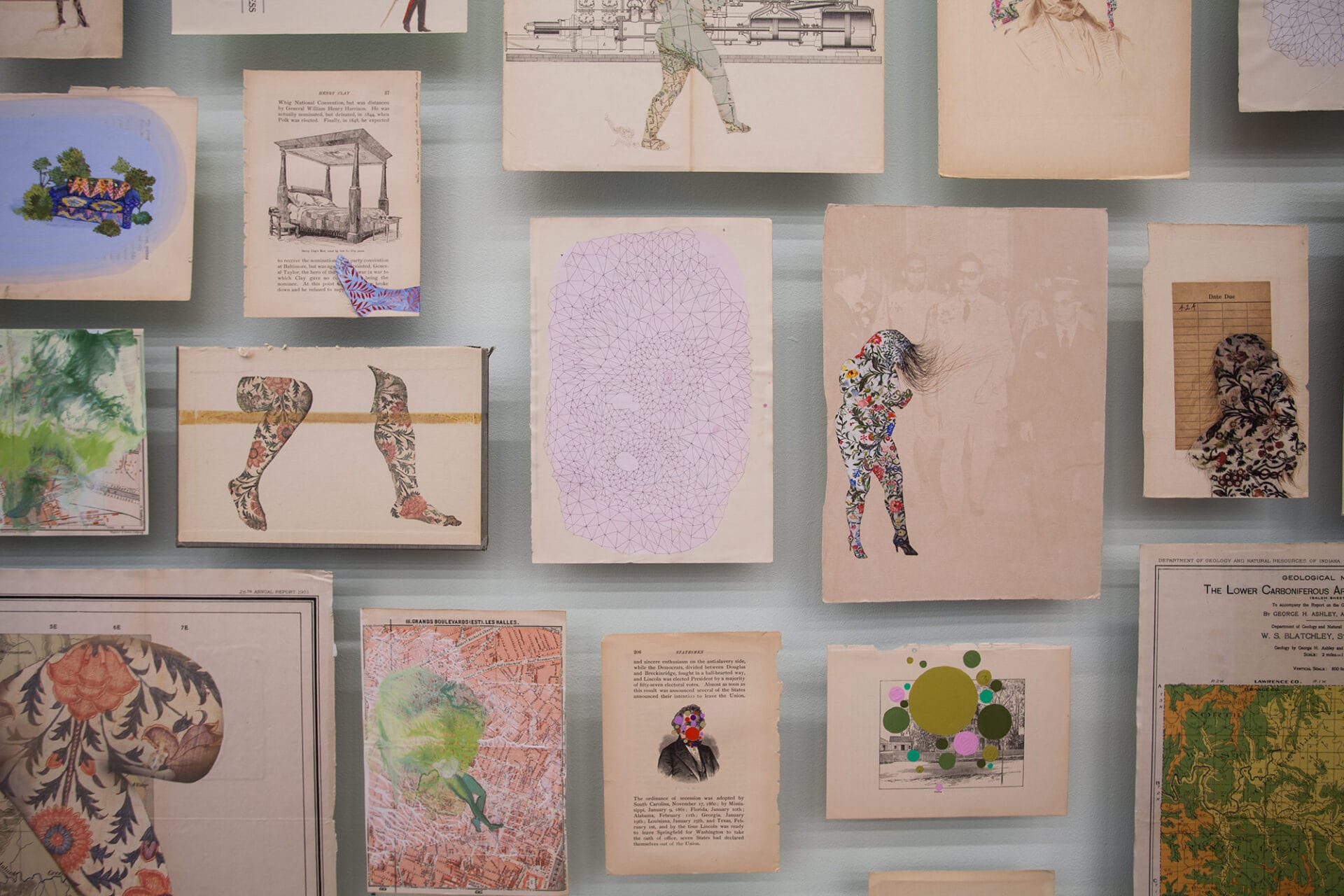 a collection of renderings including floral silhouettes, architectural renderings, and portraits on found book pages arranged on a wall