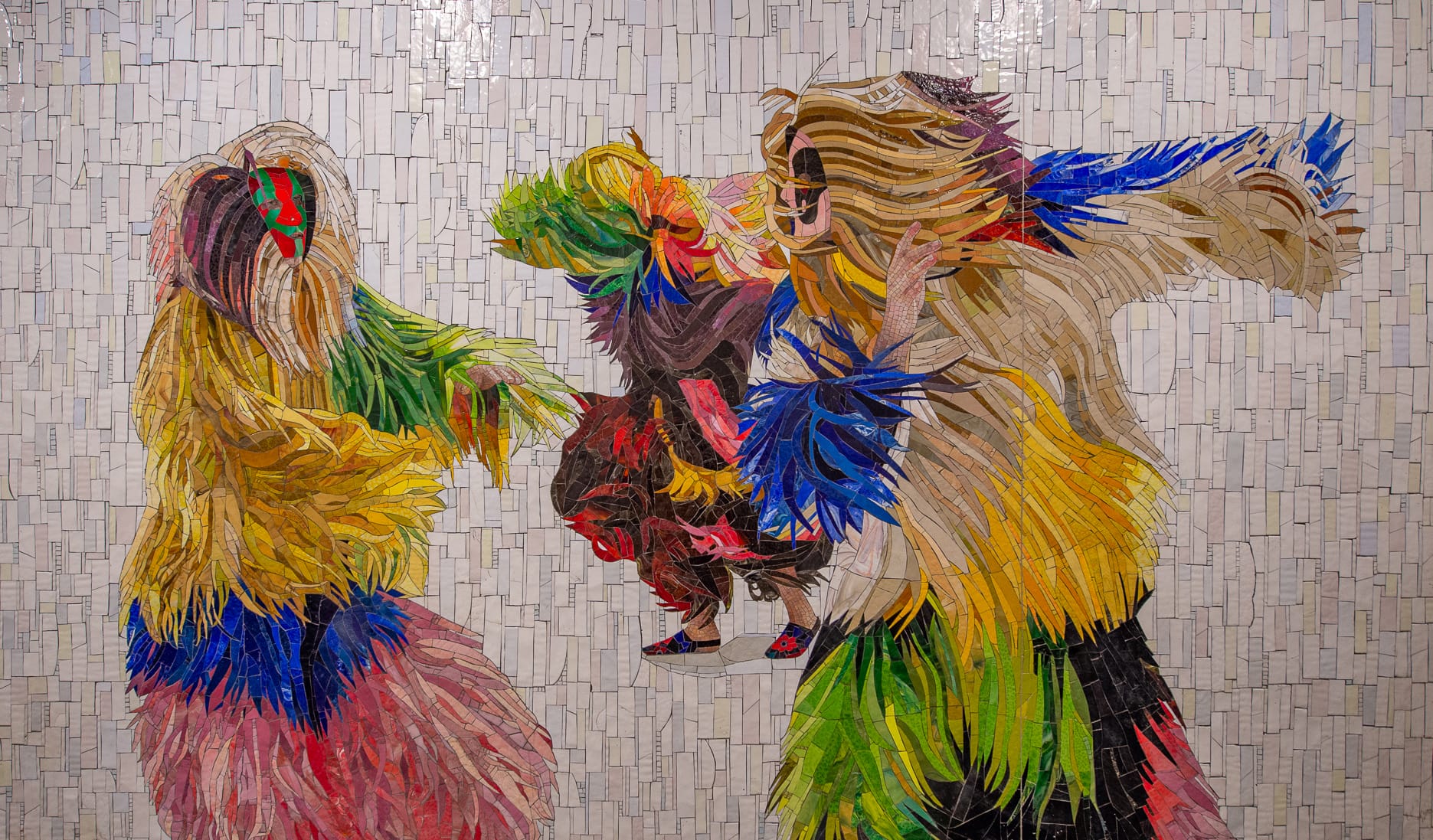 A detail of a mosaic by Nick Cave of figures with colorful, furry suits on, dancing.